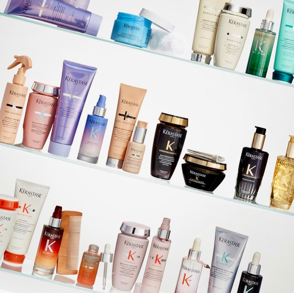  Selection of Kérastase haircare products from multiple collections arranged together, available at Curious Salons in Calgary, Canada