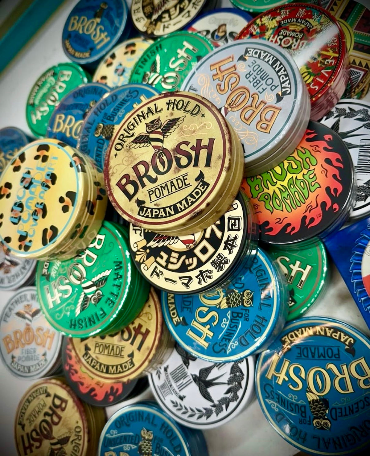 Colourful BROSH pomade tins arranged together