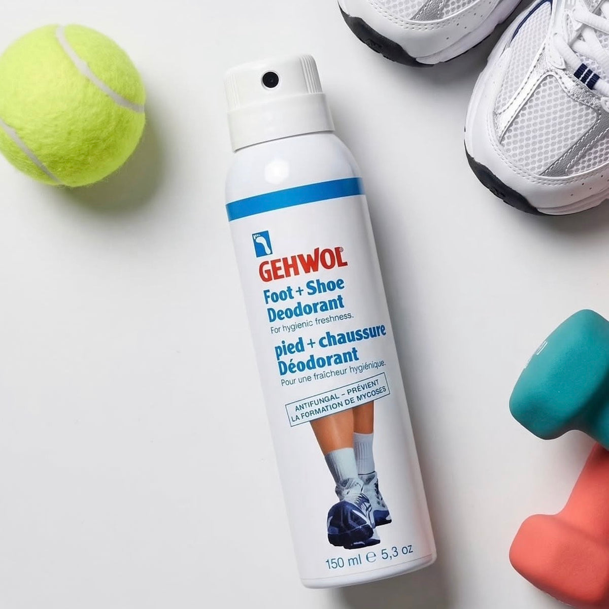 GEHWOL foot spray beside a tennis ball and trainers