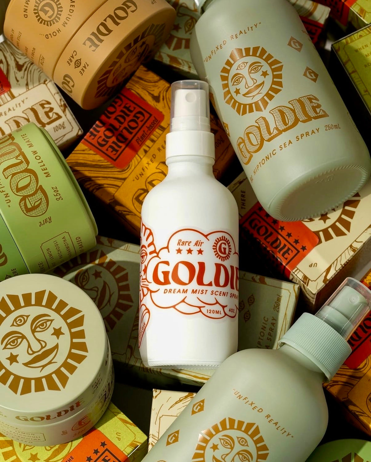 Goldie Provisions hair styling products arranged on a patterned background