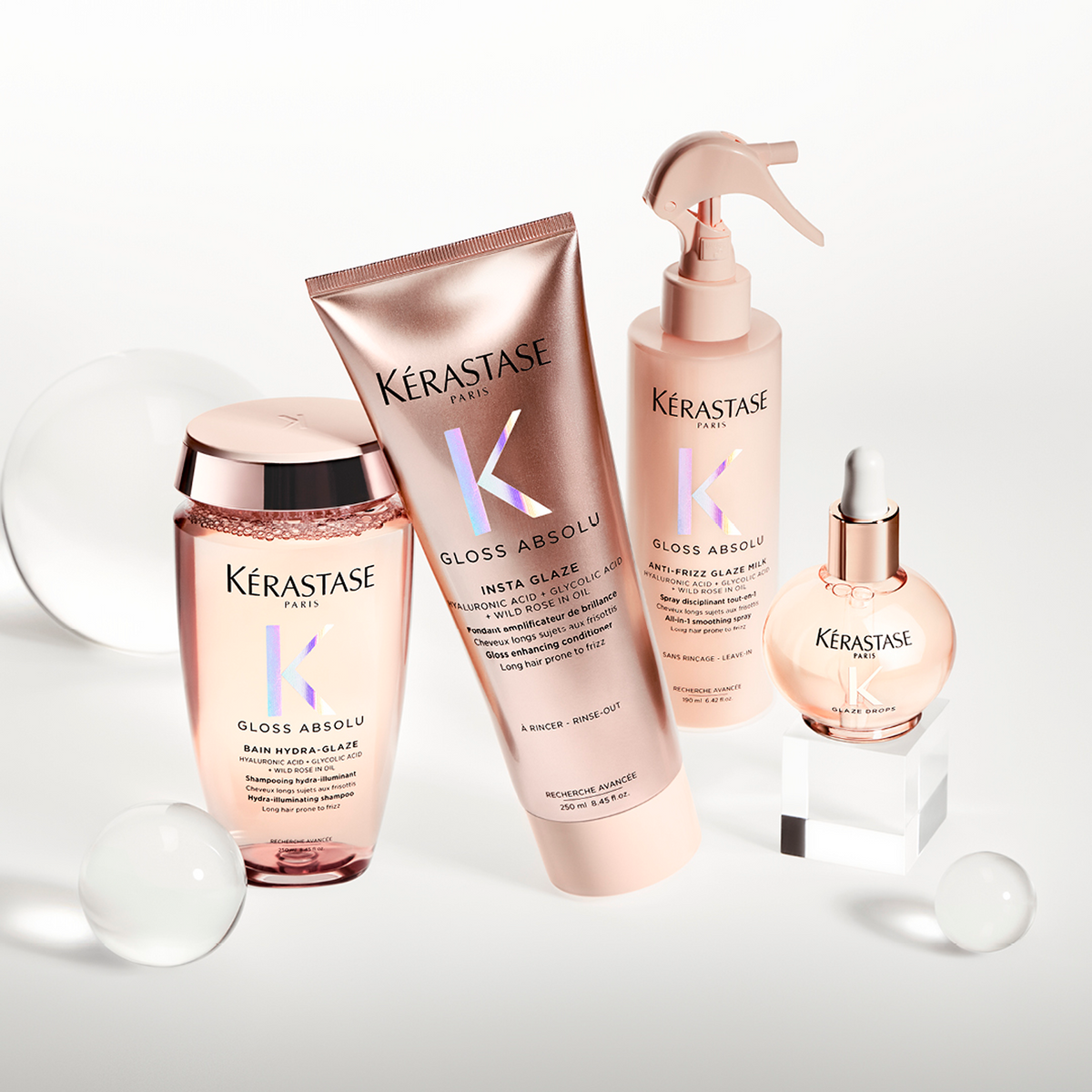 Kérastase Gloss Absolu pink haircare products with styling props