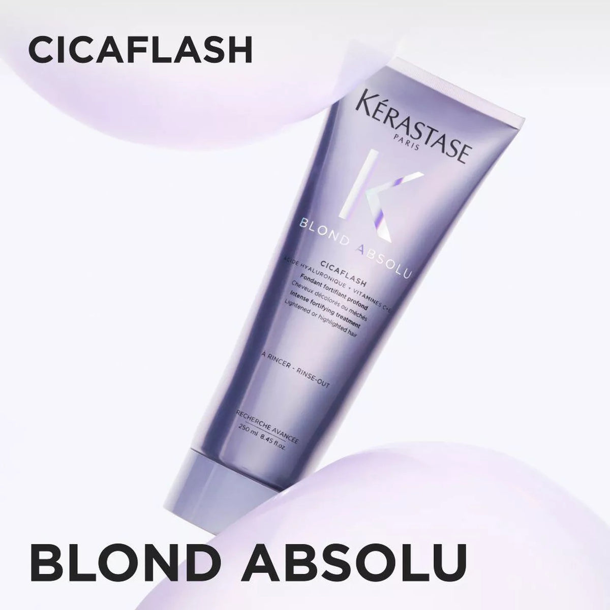 A tube of Kérastase Paris Blond Absolu Cicaflash hair developer, shown diagonally on a clean white background with soft lavender abstract shapes and bold black text overlays.