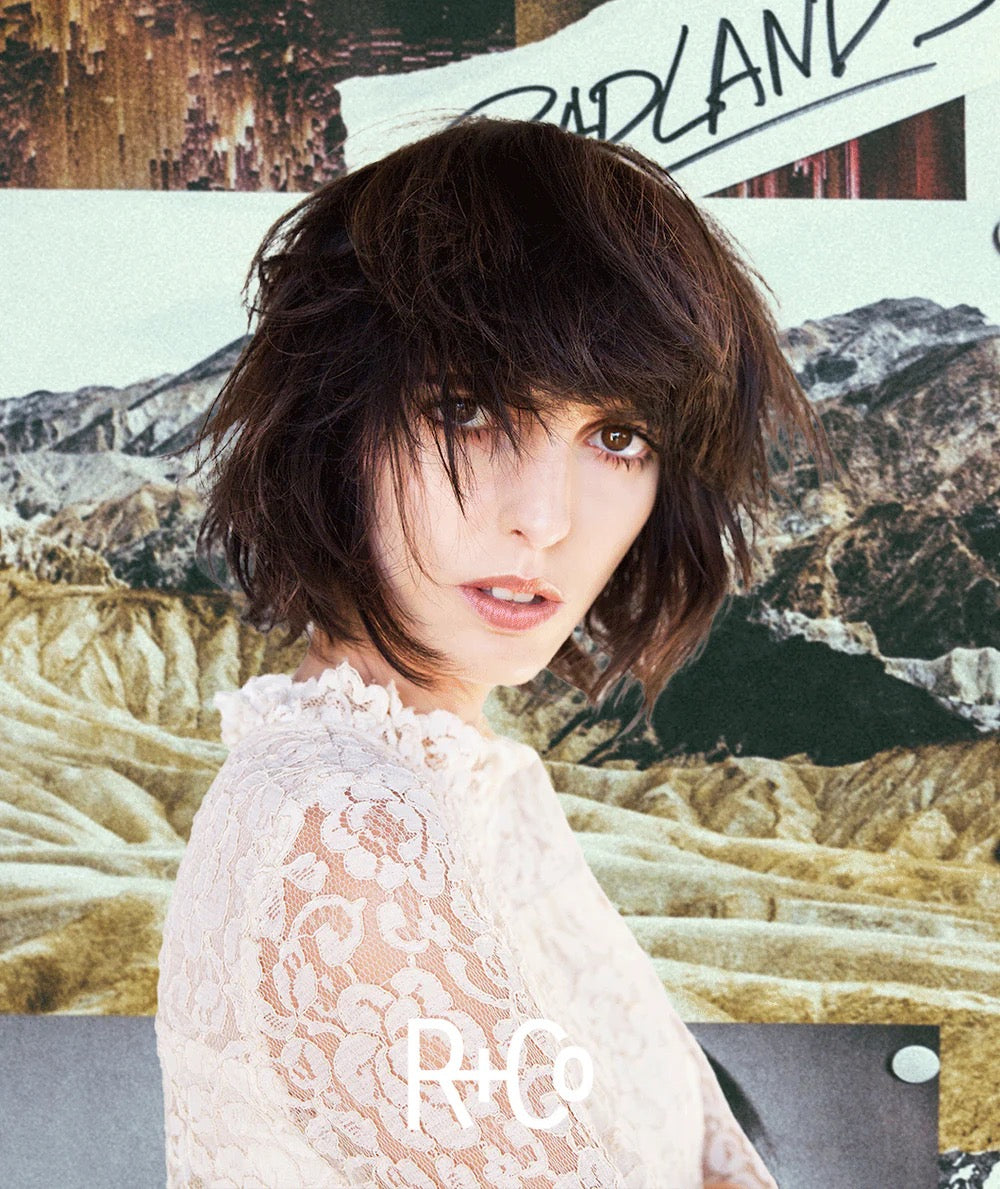 Person with short dark hair wearing a white lace top against a collage background with mountains and text.