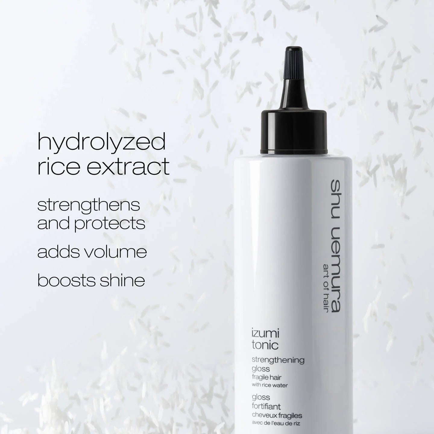 Shu Uemura hair tonic bottle with text on a textured white background