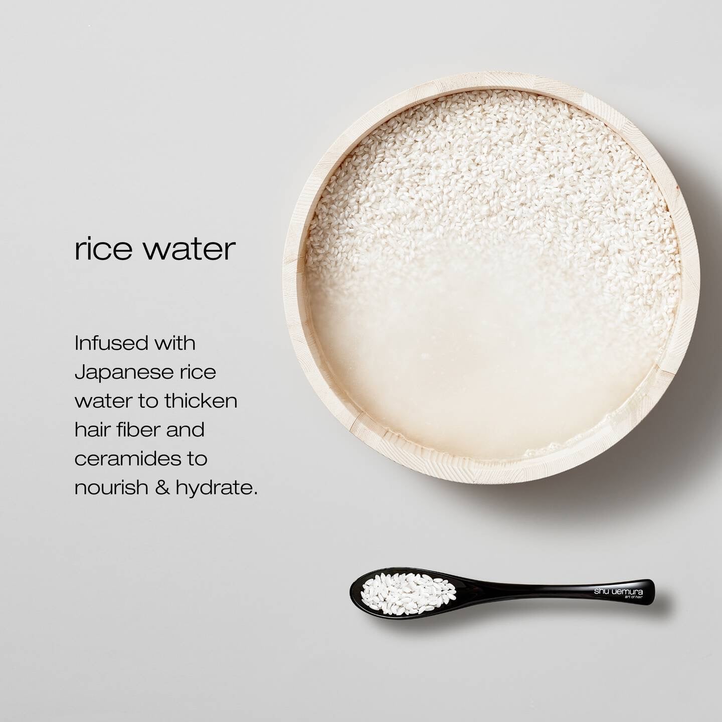 Bowl of rice water with a spoon on a light gray background