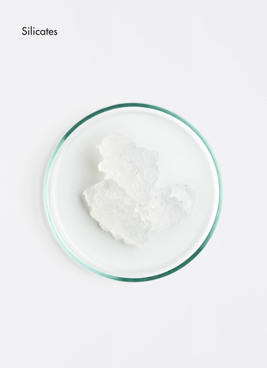 White powder in a glass bowl on a white background with 'Silicates' text.