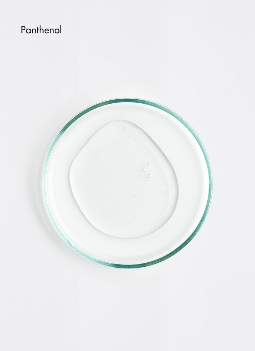 Clear plastic container with green rim on a white background, featuring the brand 'Panthenol'.