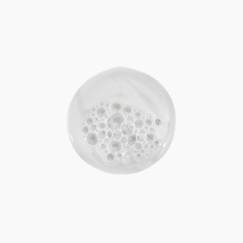 White shower head with water droplets on a white background Kevin Murphy YOUNG.AGAIN.WASH restorative softening shampoo for dry brittle hair in Canada at Curious Salons 