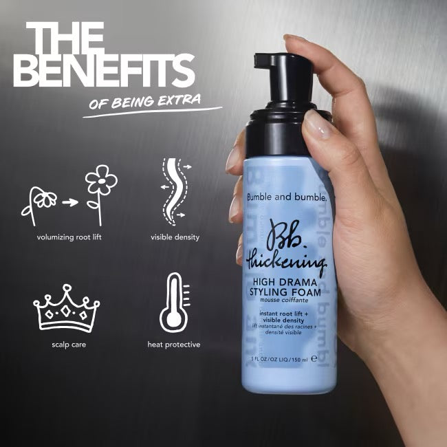 Hand holding a bottle of Bumble and Bumble Thickening Styling Foam with product benefits on a dark background