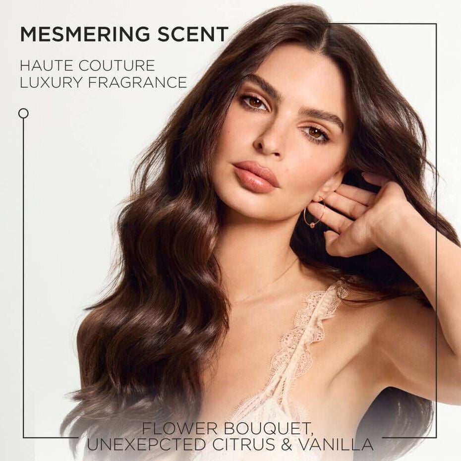 Advertisement for a perfume with a model holding her hair against a white background