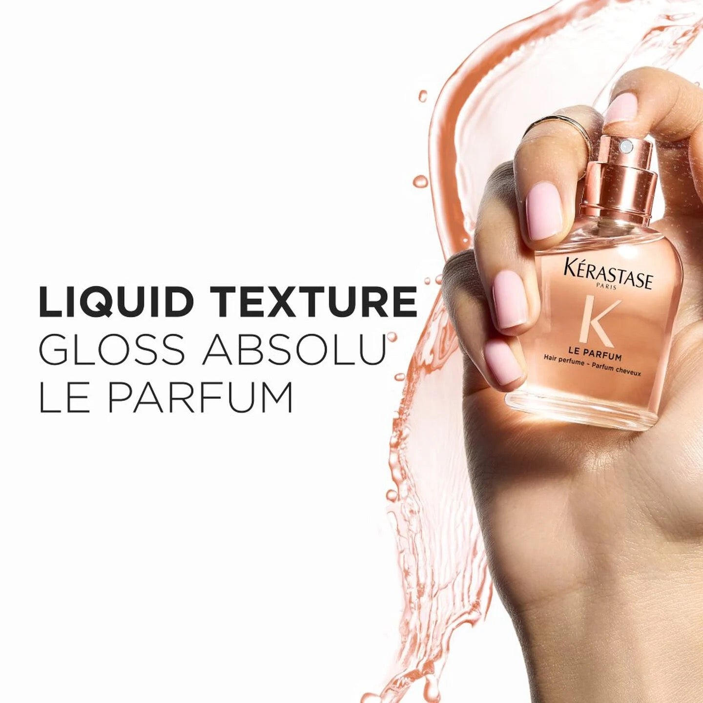 Kérastase Gloss Absolu Le Parfum bottle held by a hand with pink nail polish on a white background.