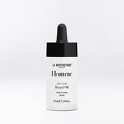 La Biosthetique Homme Beard Oil in a white bottle with a black dropper cap, centered on a light gray background.