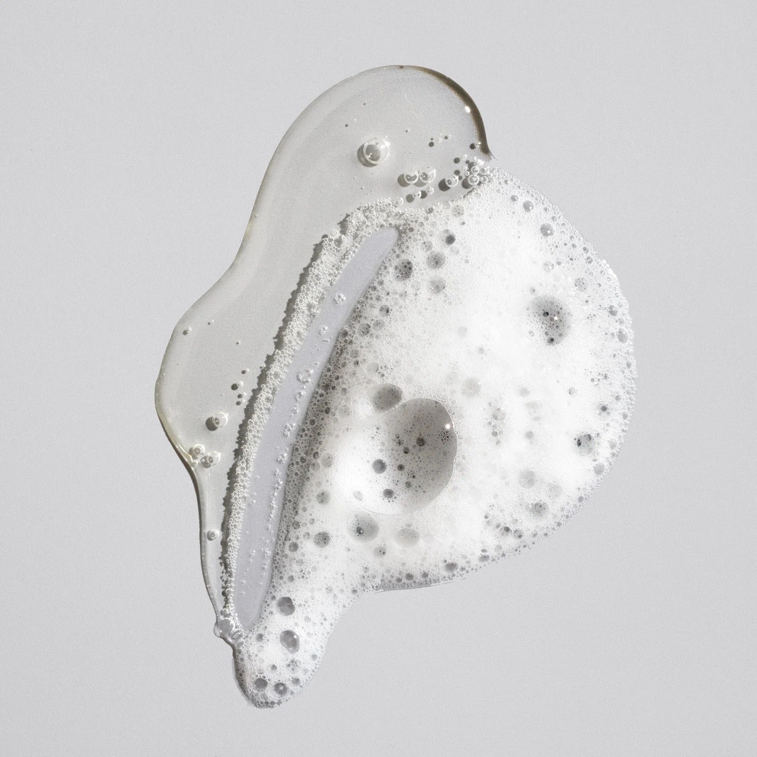 Close-up of a droplet of cOribe Signature Shampoo luxury daily shampoo for all hair types in Curious Salons Canada