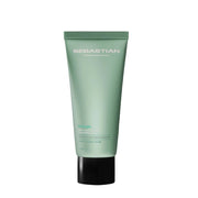 Green tube of Sebastian hair product on a gray background