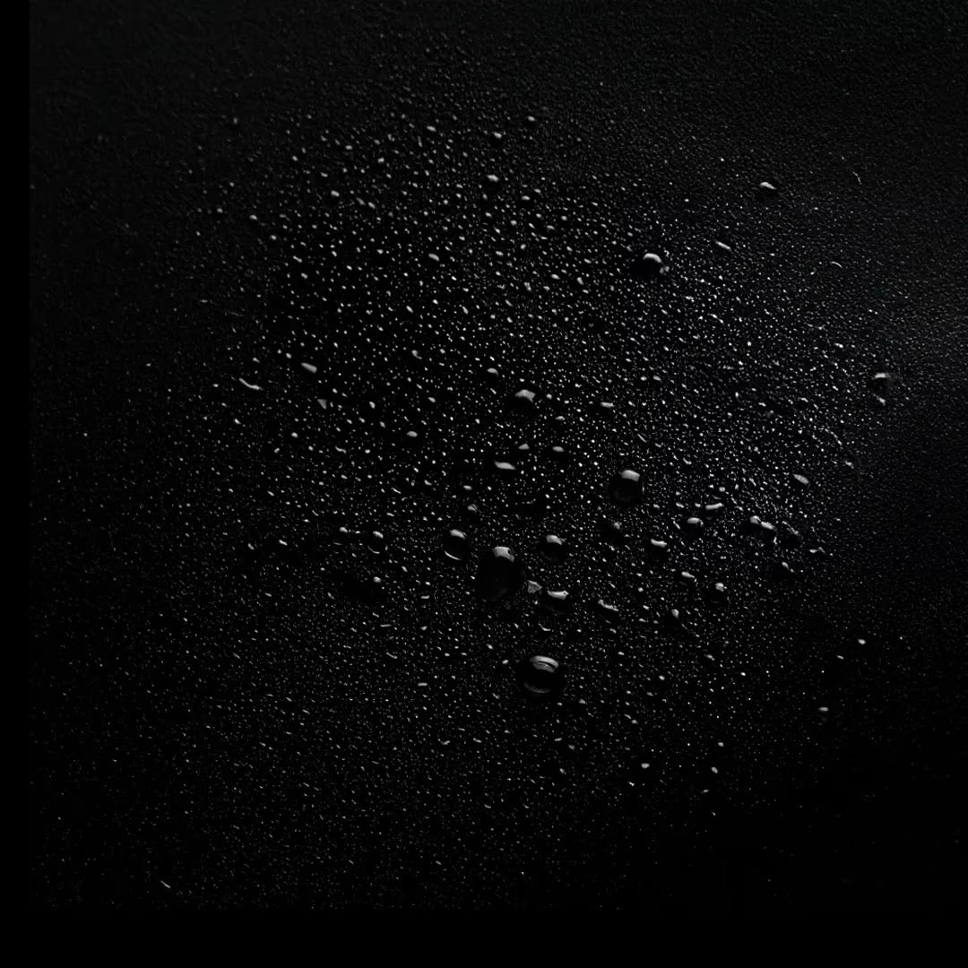 Close-up of water droplets on a black surface