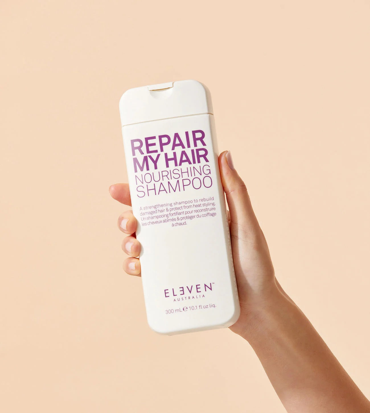 ELEVEN Australia Repair My Hair Nourishing Shampoo for damaged hair in Canada at Curious Salons being held by hand