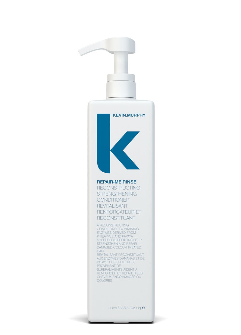 Kevin Murphy Repair-Me Rinse reconstructing strengthening conditioner in a tall white pump bottle with a blue 'K' logo, shown on a white background.