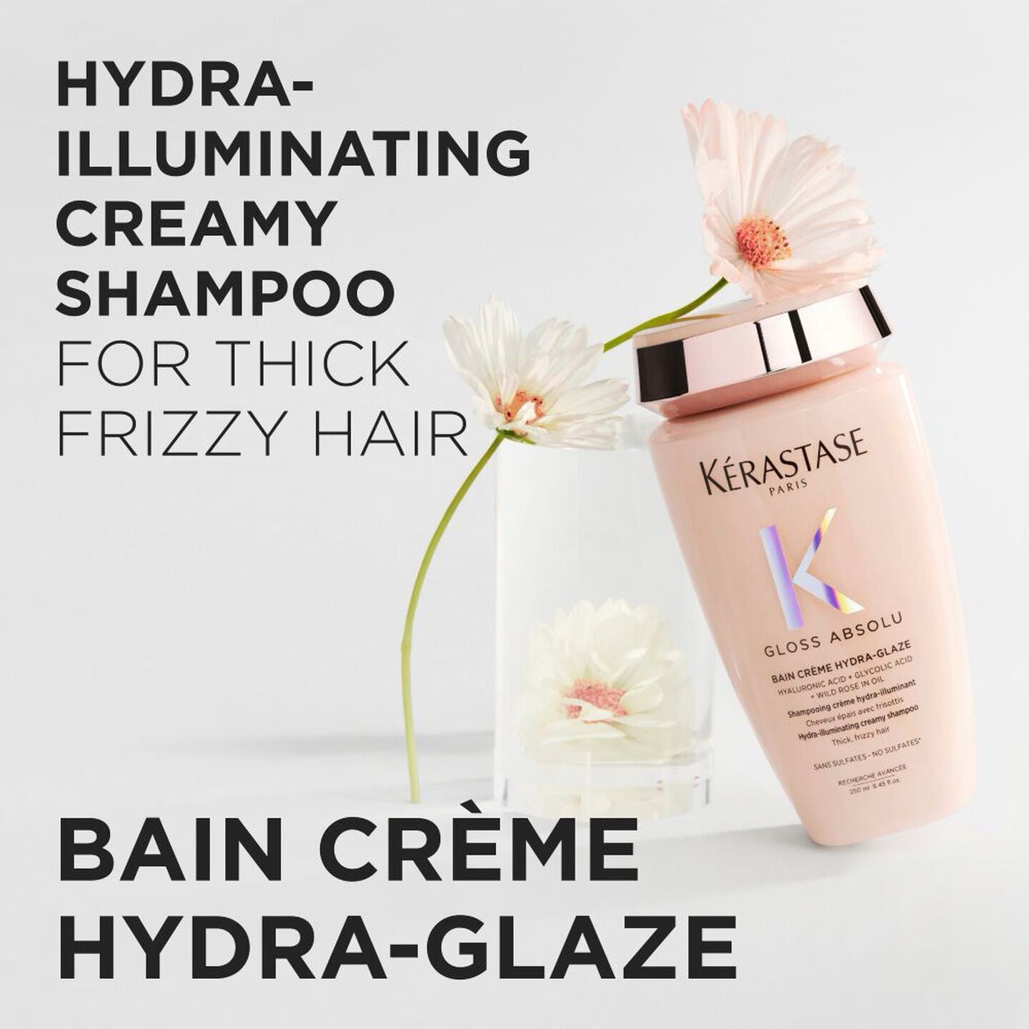 Kérastase shampoo bottle with flowers on a light background