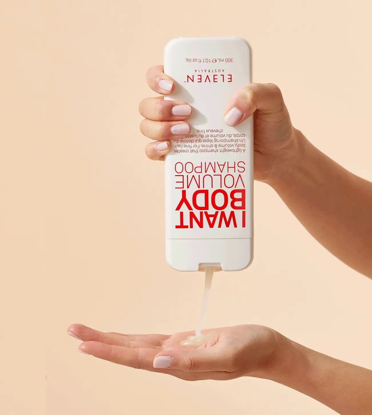 Hand holding a bottle of ELEVEN Australia I Want Body Volume Shampoo bottle for fine, flat hair and lightweight volume Canada