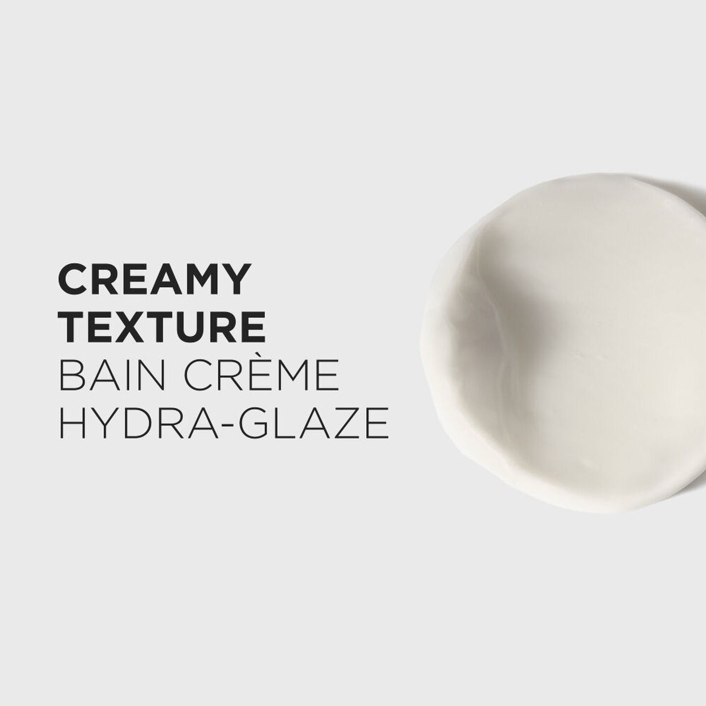 Creamy texture product with 'Bain Crème Hydra-Glaze' text on a light gray background