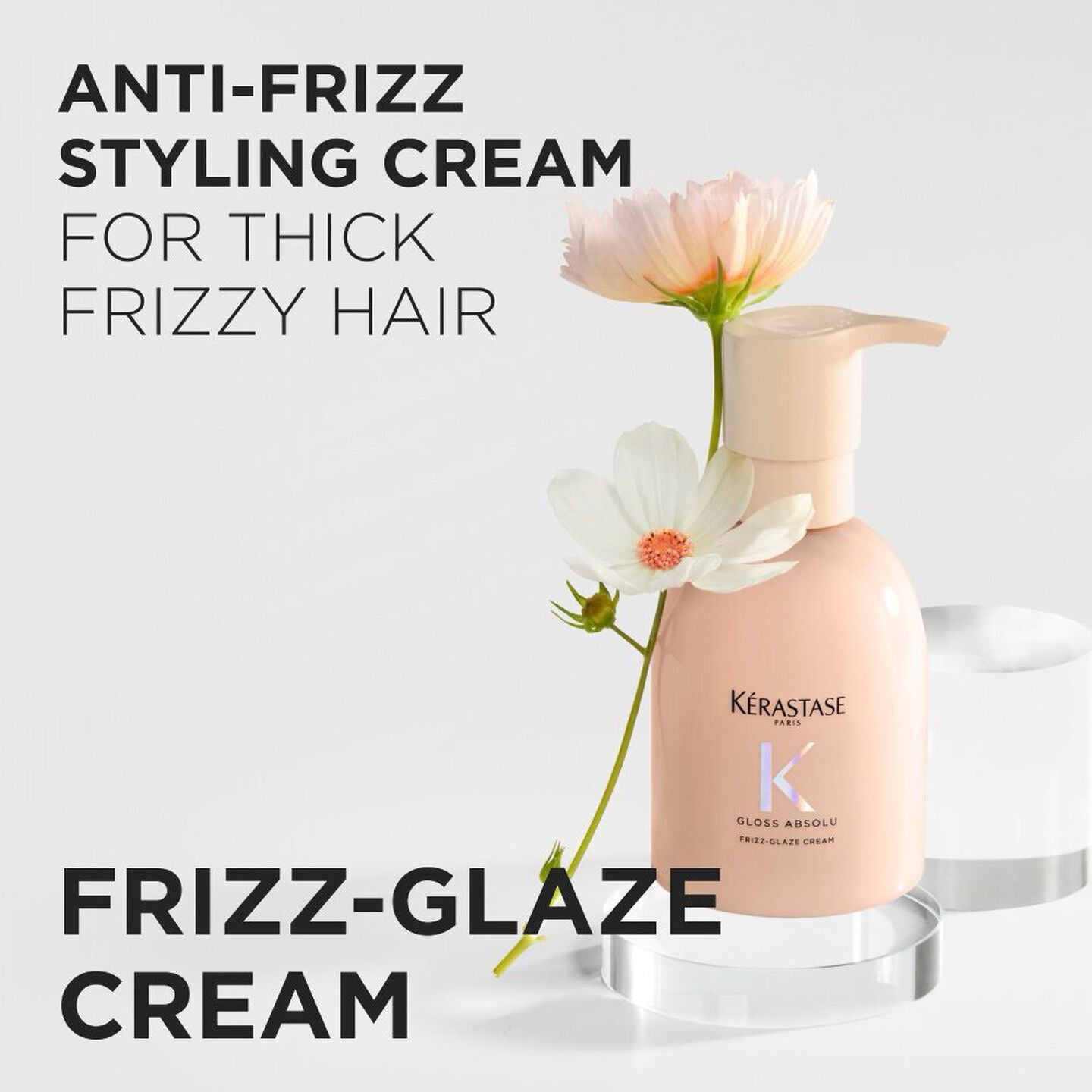 Kérastase anti-frizz styling cream bottle with flowers on a light background