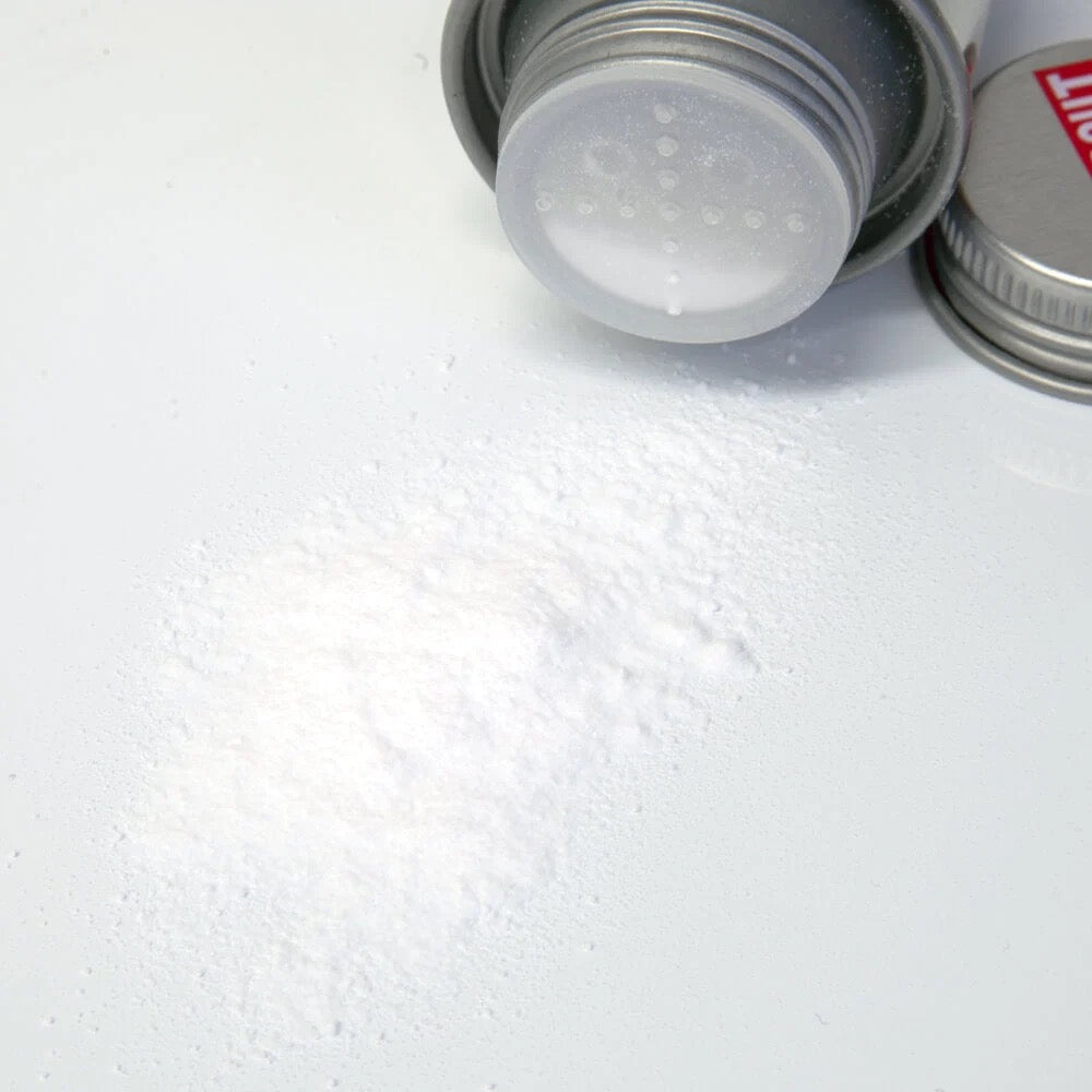 Silver container with a white lid on a textured white surface