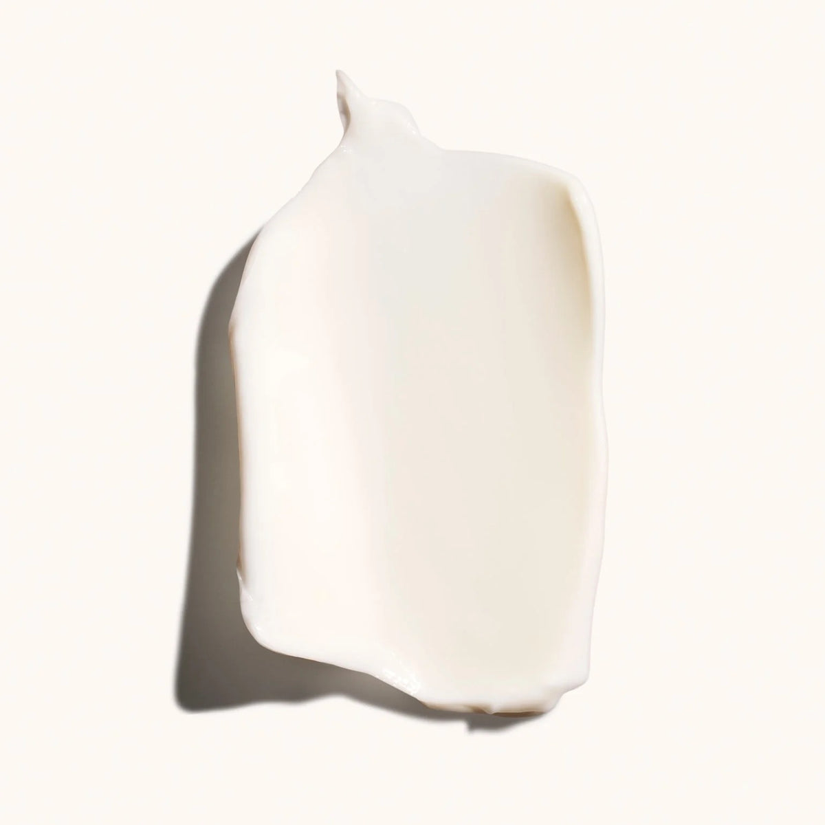 White ceramic vase on a white background Oribe body wash bottles on a beige background available at Curious Salons