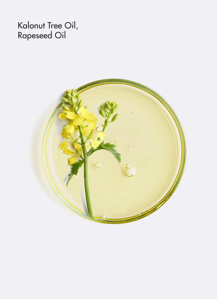 Clear oil with a yellow flower and green leaves on a white background