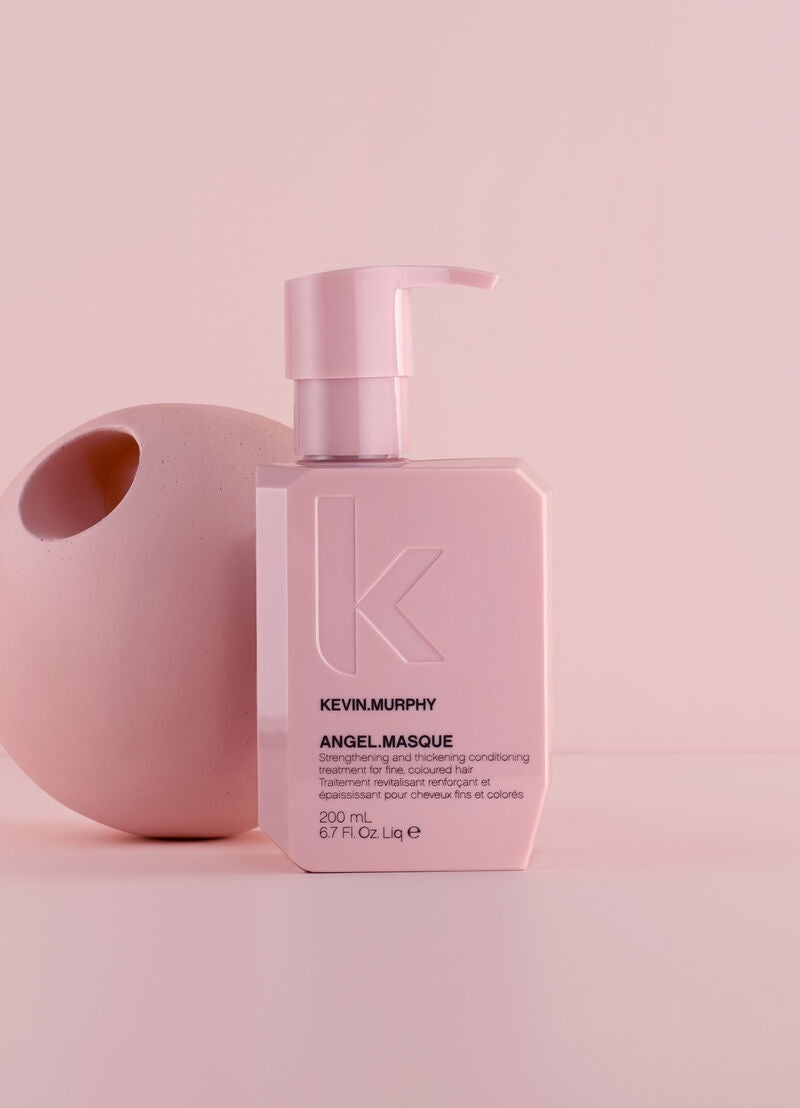 KEVIN.MURPHY ANGEL.MASQUE strengthening treatment for fine damaged hair available in Canada at Curious Salons on a pink background