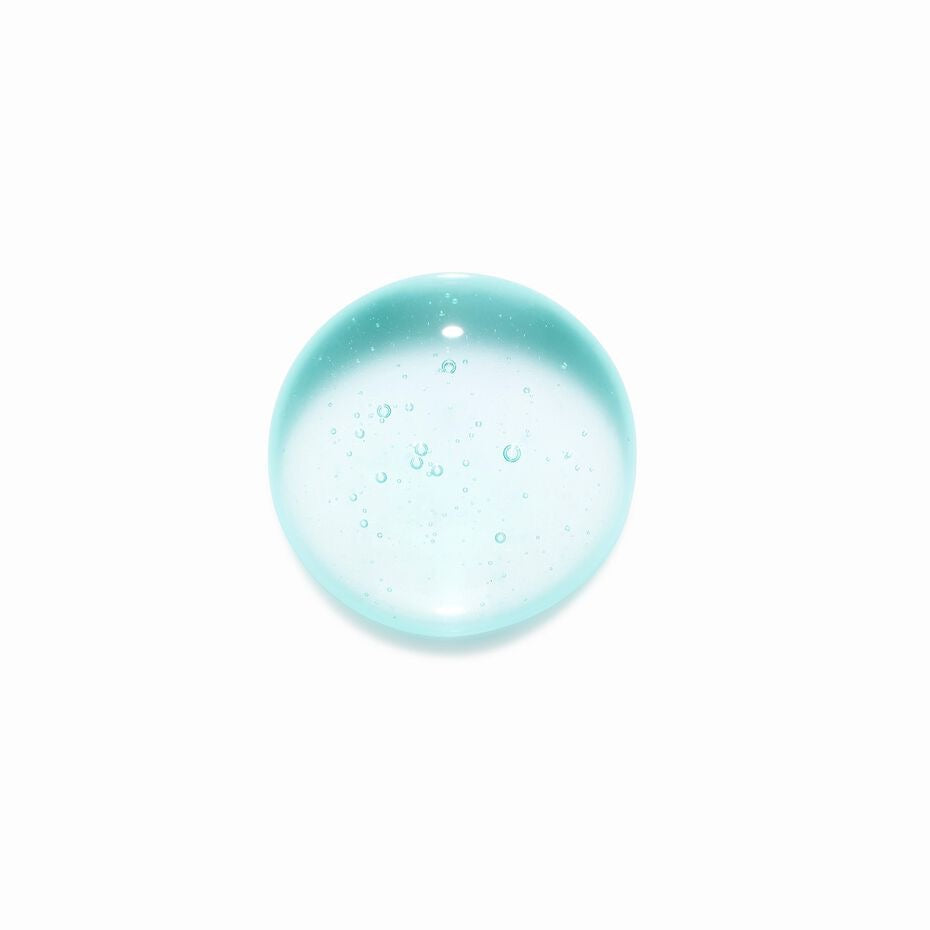 Clear blue glass gemstone with air bubbles on a white background Kérastase Spécifique Bain Vital Dermo-Calm shampoo for sensitive itchy scalp in Canada