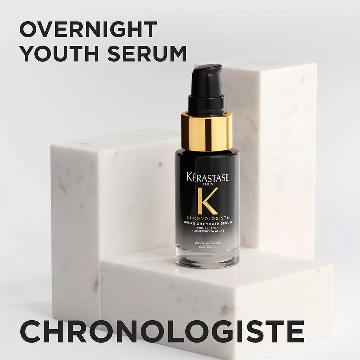 Kérastase Chronologiste Overnight Youth Serum bottle on a marble surface with text overlay.