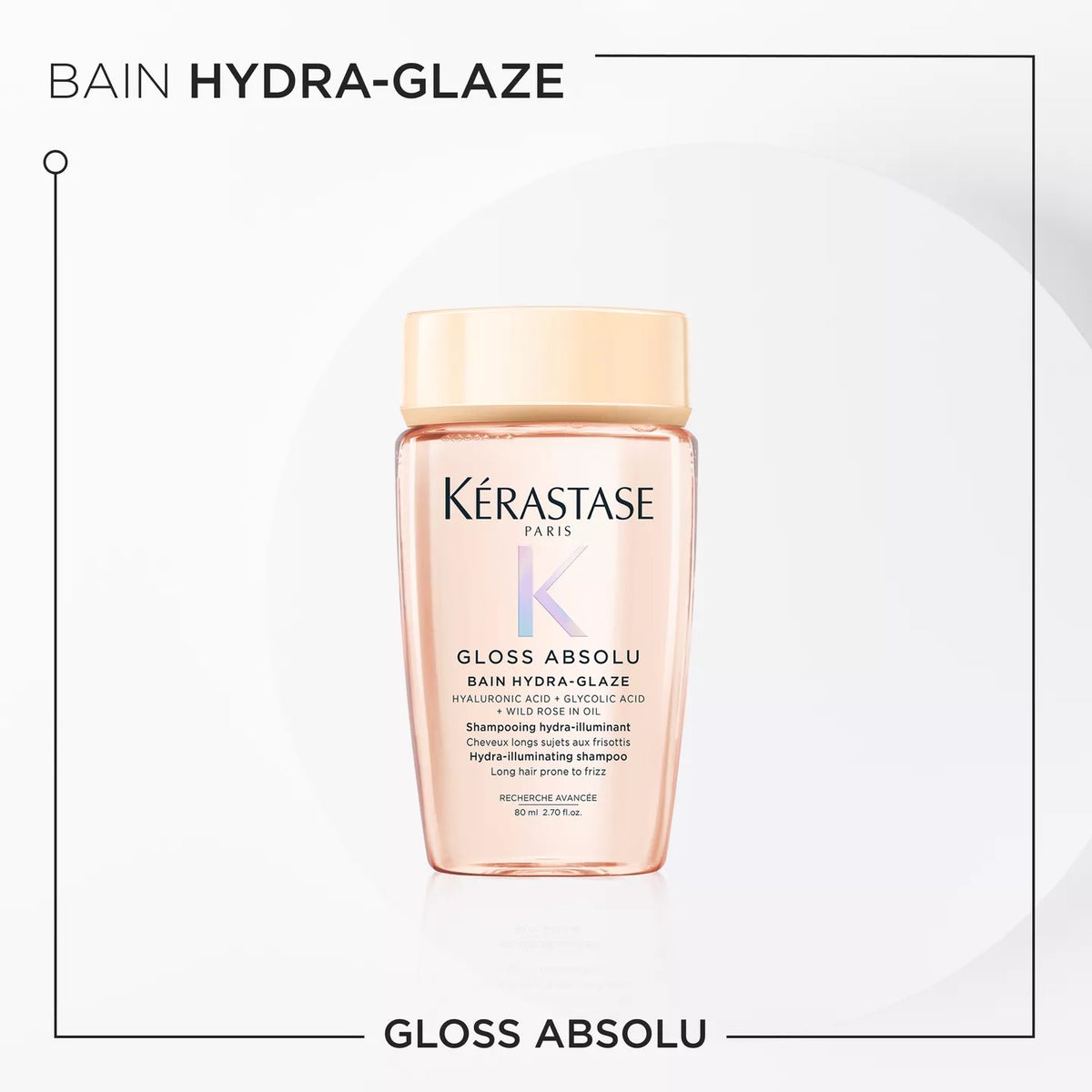 Kérastase Paris Bain Hydra-Glaze Gloss Absolu shampoo bottle in a pale peach-pink color with a light beige cap, centered on a white background with black text and a thin border.