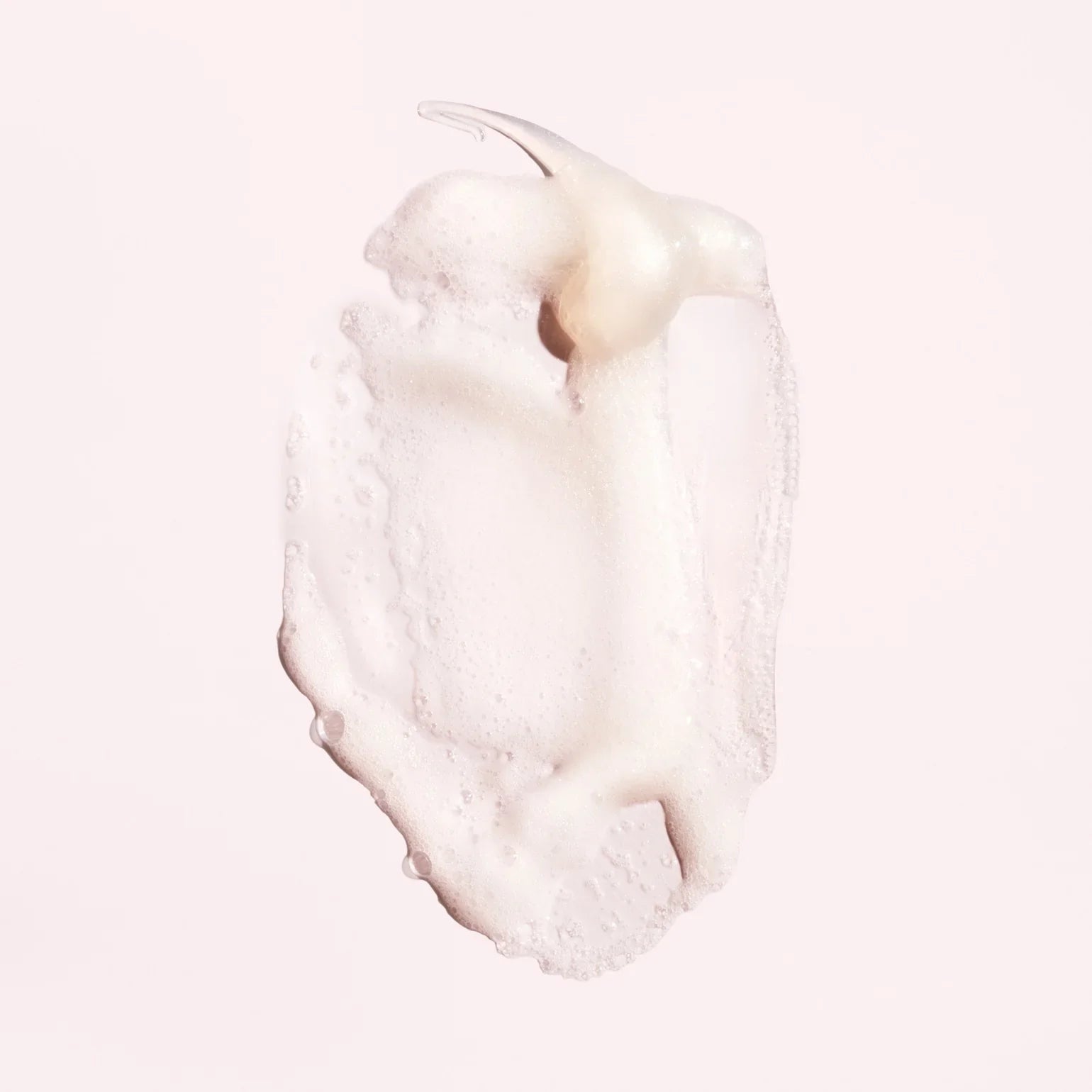 Close-up of a smooth, white cream texture Oribe Serene Scalp Balancing Shampoo for dry flaky scalp care in Canada