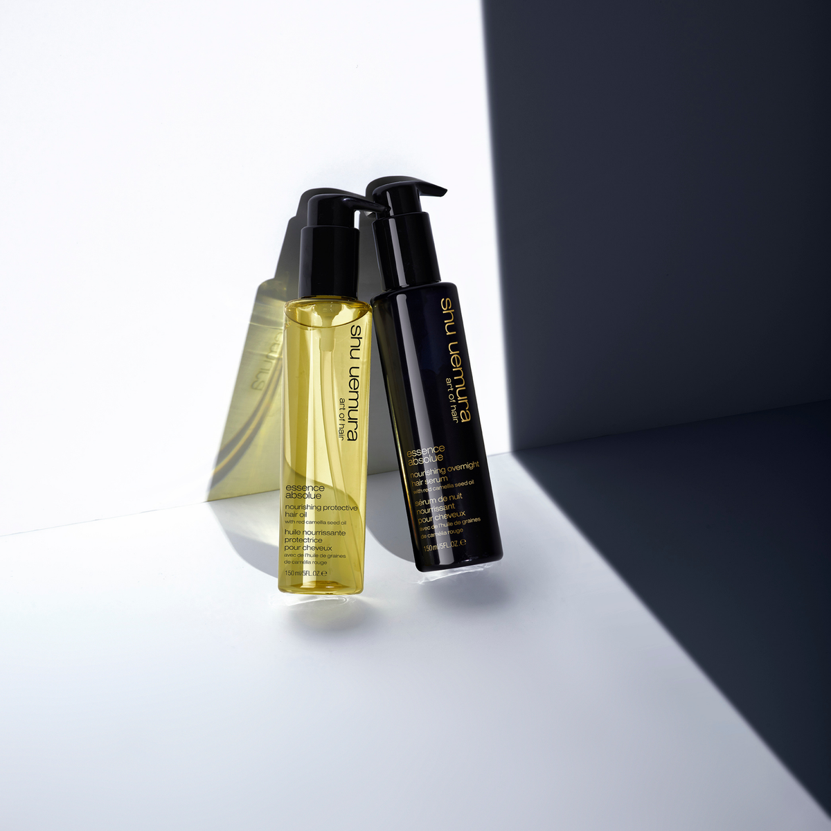 Two bottles of Eufaula Nue hair care products on a white and gray background