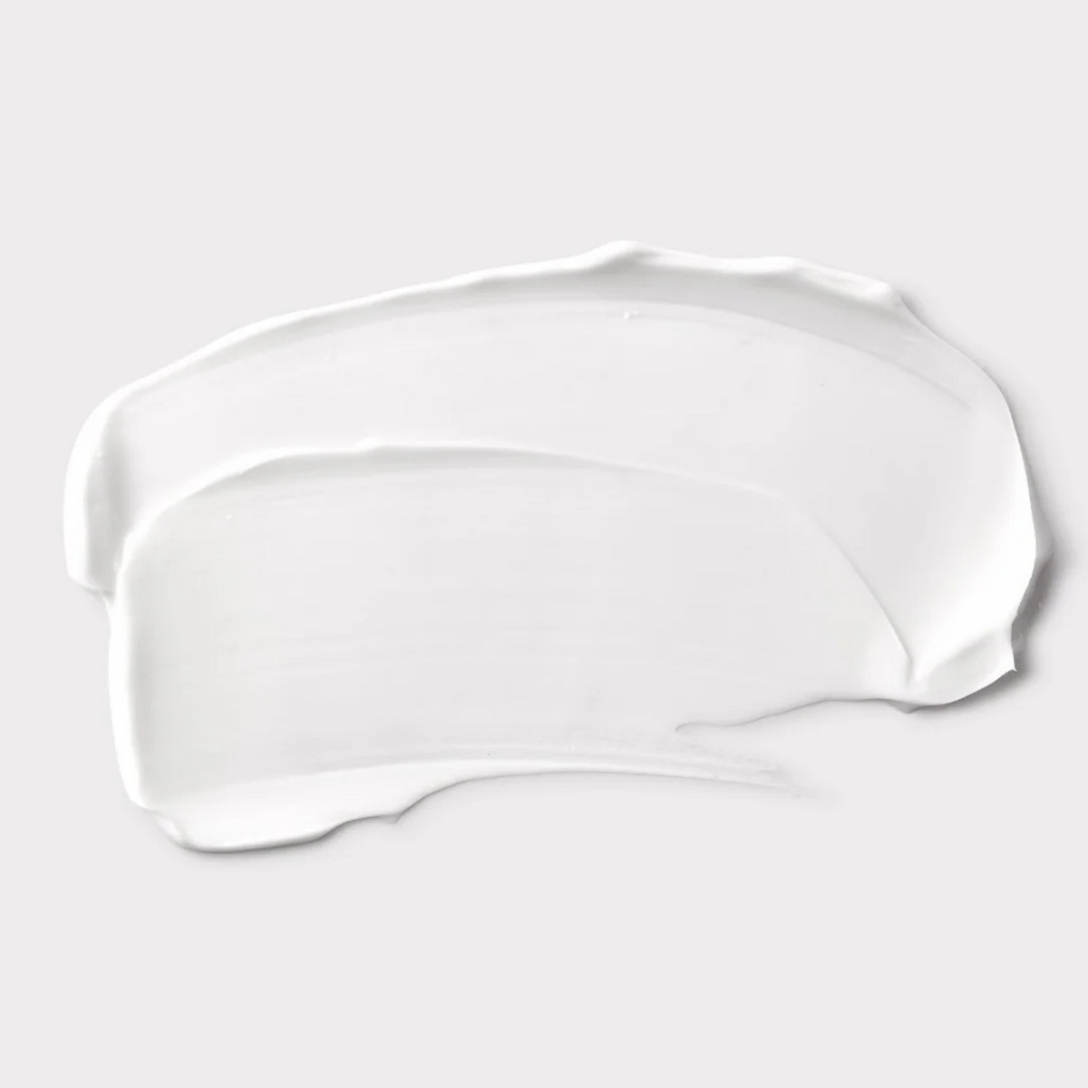 White liquid droplet or smear on a light gray background Shu Uemura Izumi Tonic 