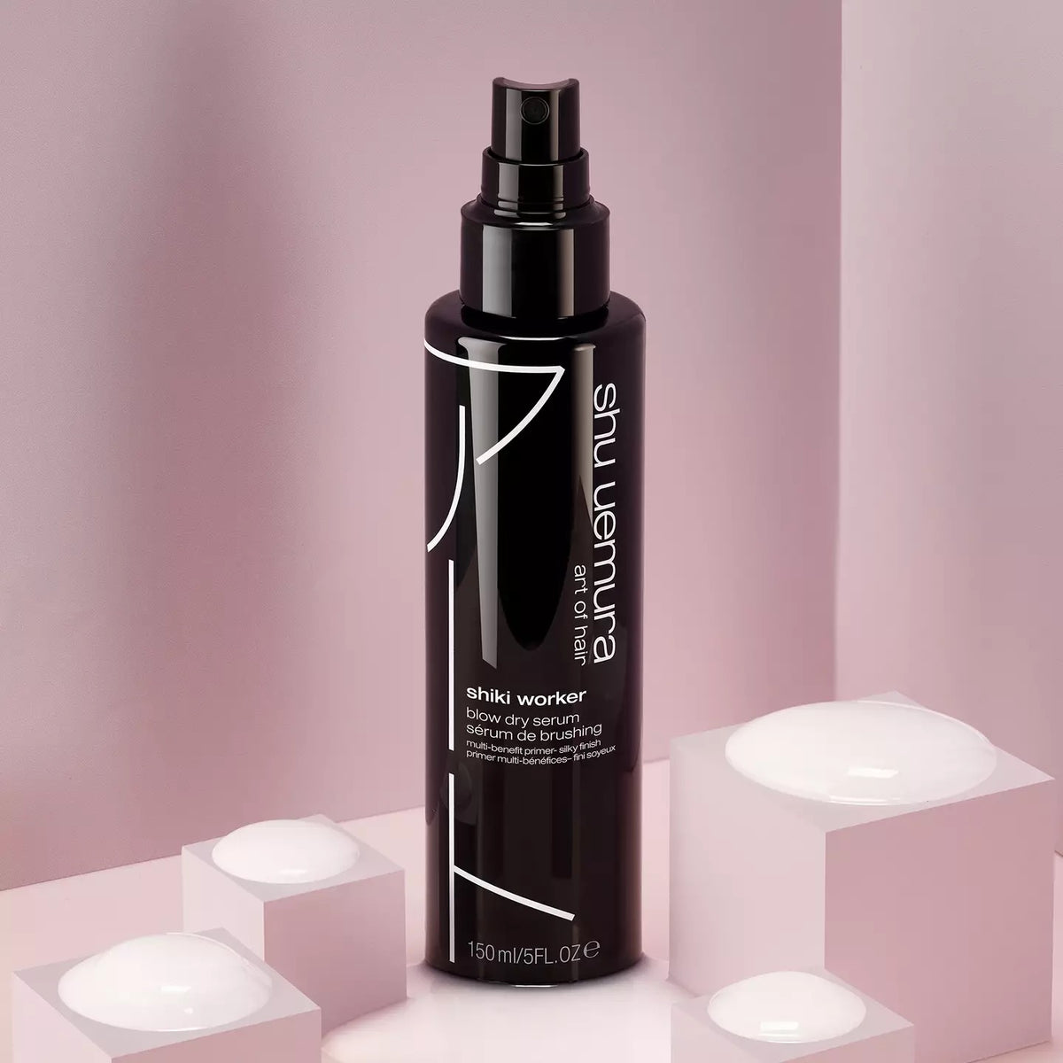 Shu Uemura Shiki  Worker serum bottle on a pink geometric background