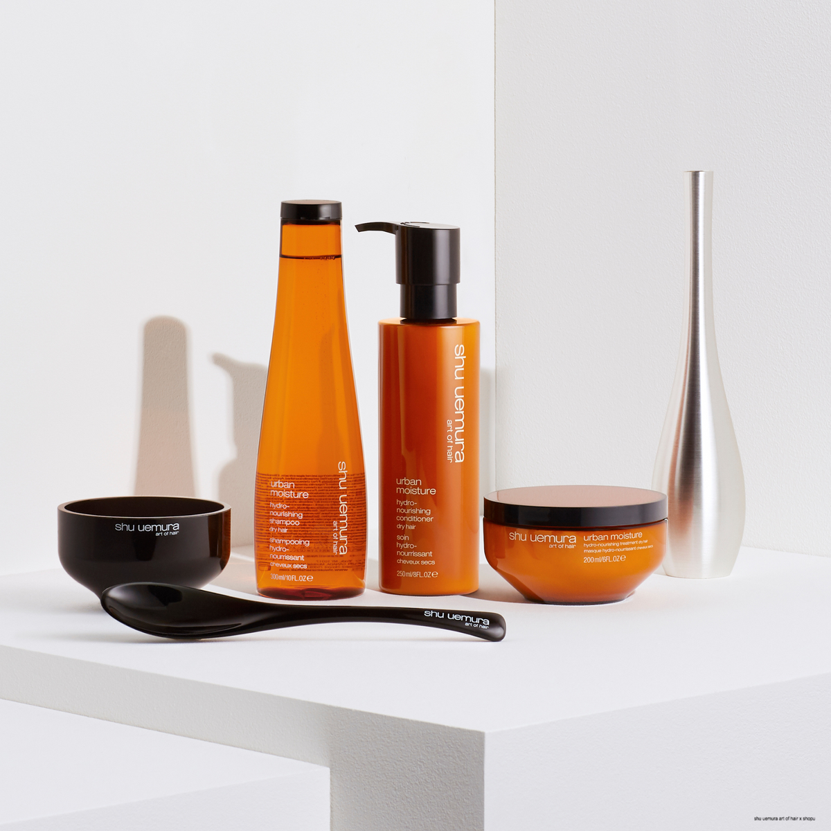 Shu Uemura Urban Moisture care products including bottles and a bowl on a white surface.
