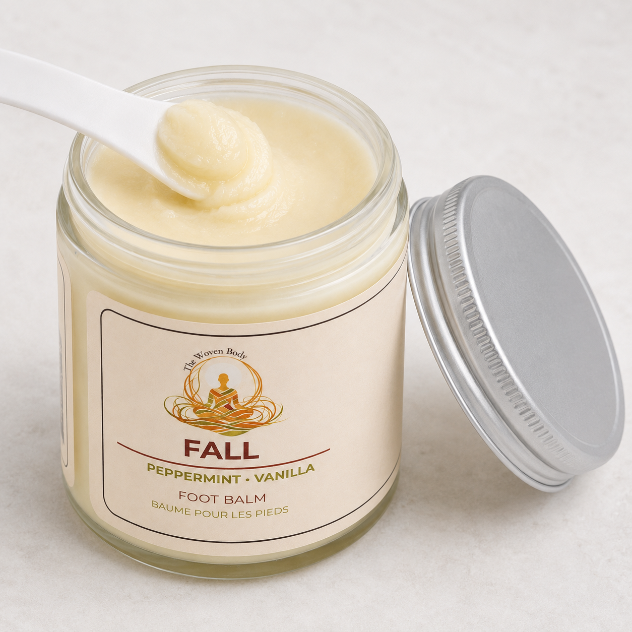 An open glass jar of The Woven Body Peppermint Foot Scrub — 5 oz recyclable glass jar, made in Calgary, Alberta CLEAN product Curious Salons