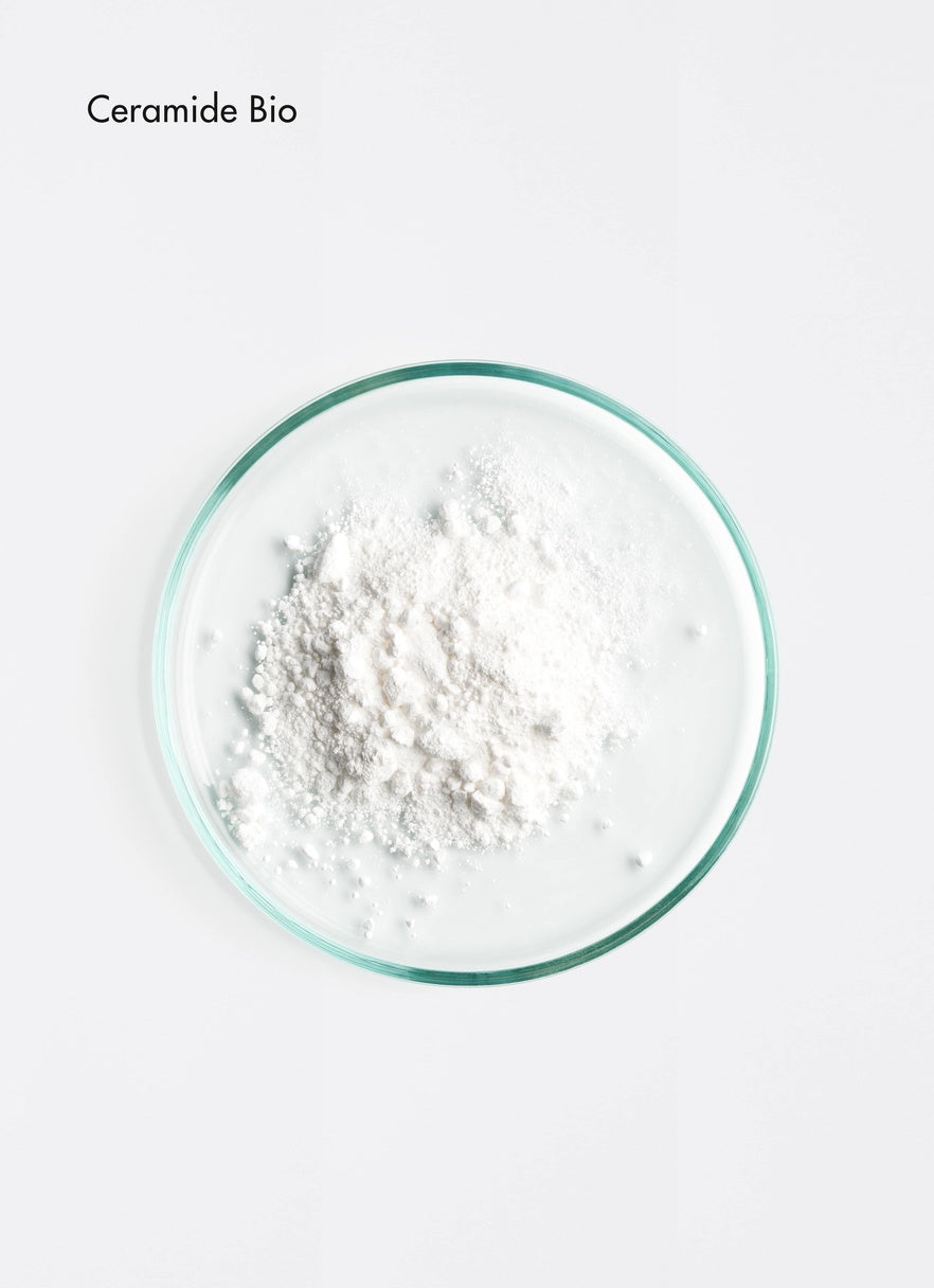 White powder in a glass bowl on a white background with 'Ceramide Bio' La Biosthétique Essentiel Classic Conditioner for soft shiny stressed hair in Canada
