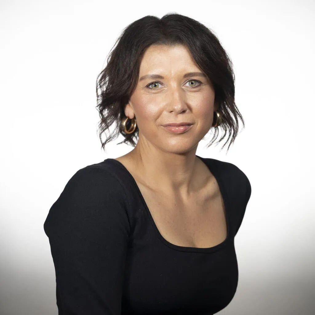 Julie Black, experienced hairstylist specializing in curly hair and bobs.