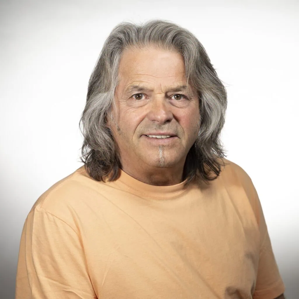 Michael John, senior stylist with 40 years of experience, excels in haircuts and formal design.