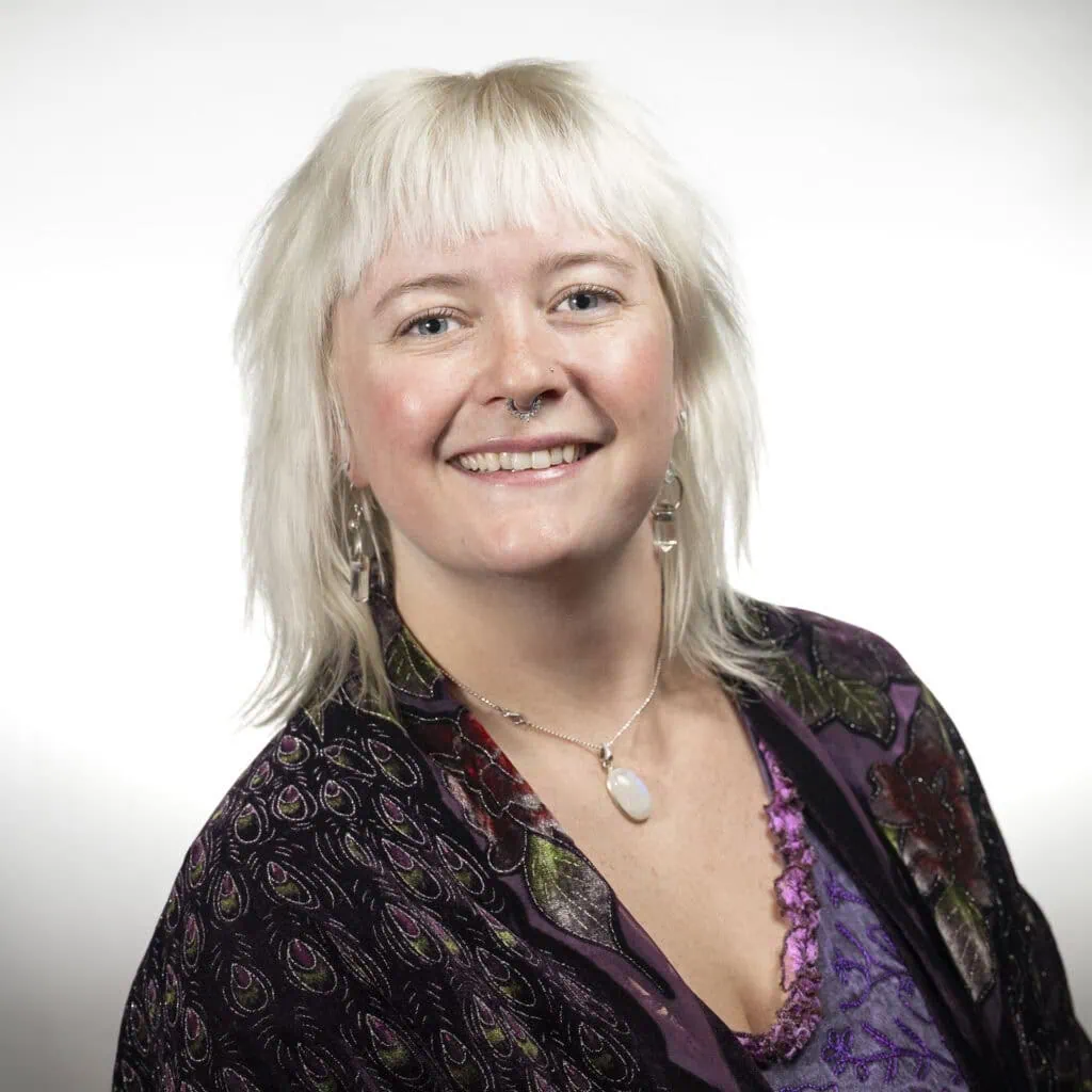 Olivia Reid, receptionist specializing in client check-ins and product knowledge.